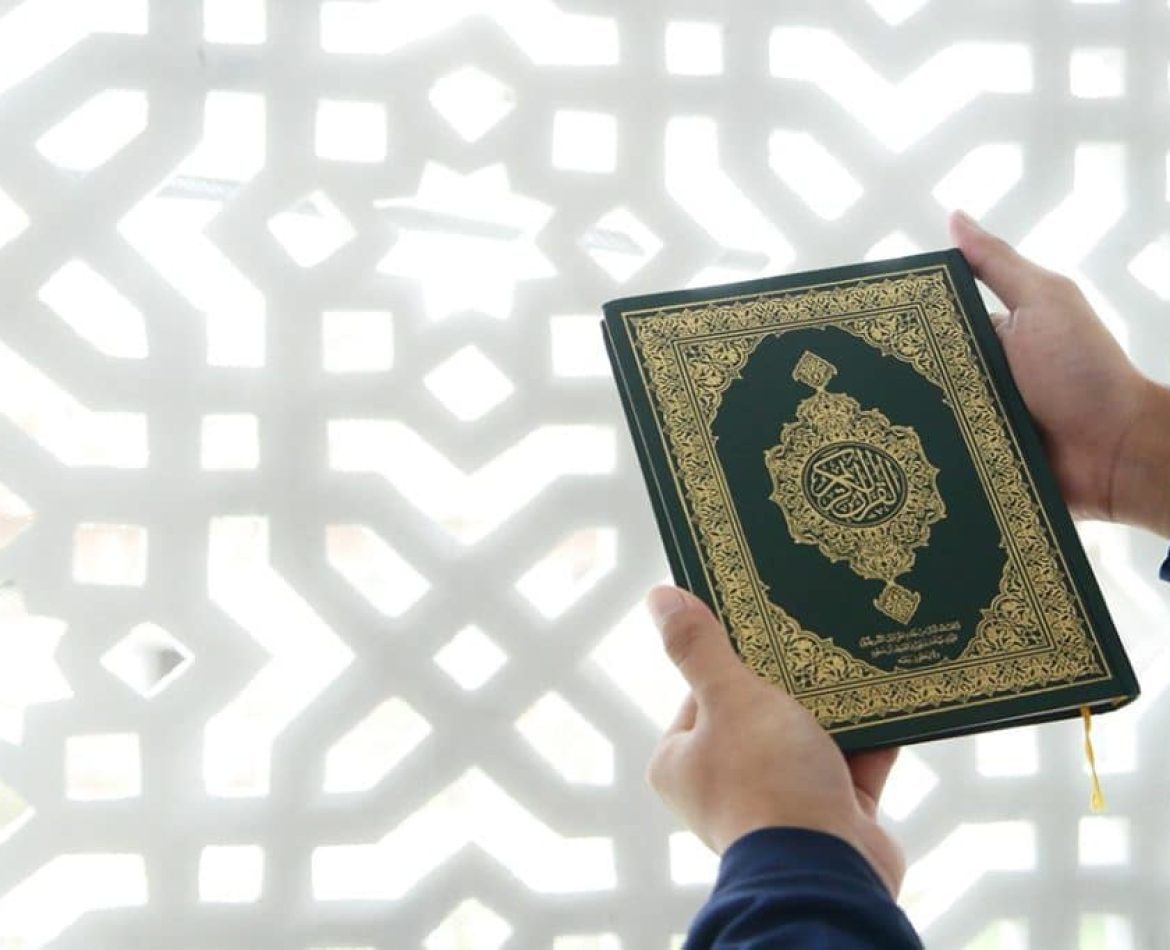 Some one holding Quran