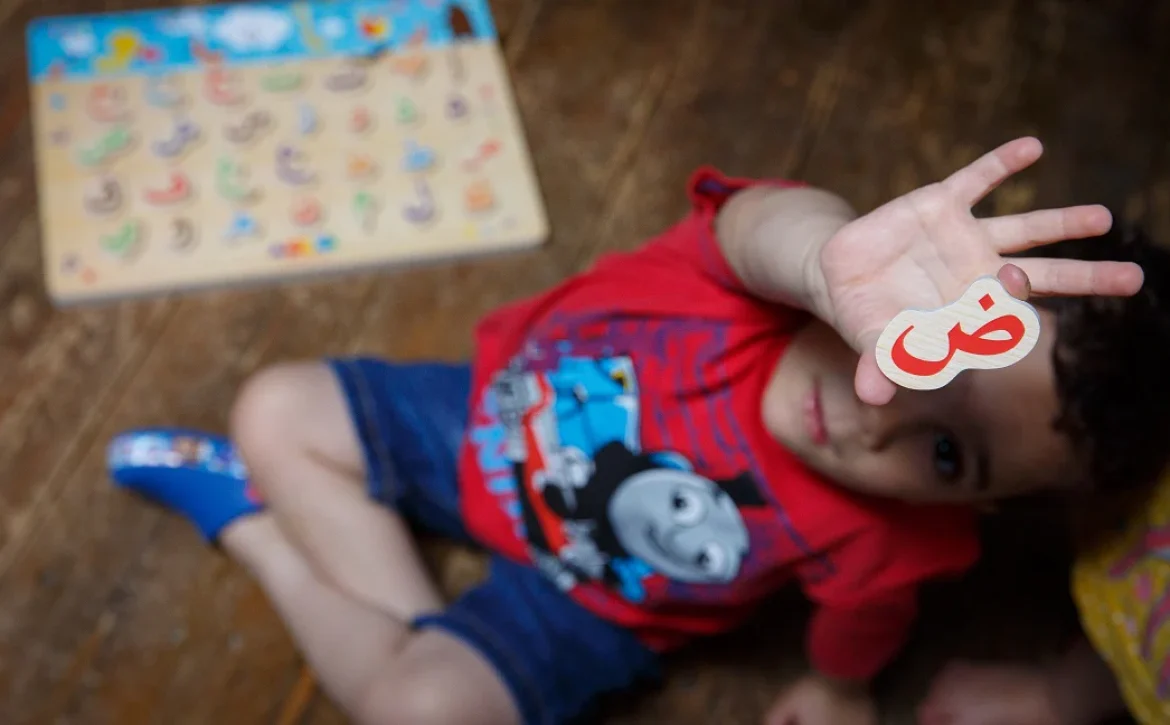 Child playing an educational Arabic alphabet learning game